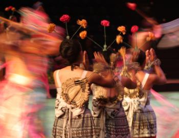 image of people dancing in hawaii, partially blurry