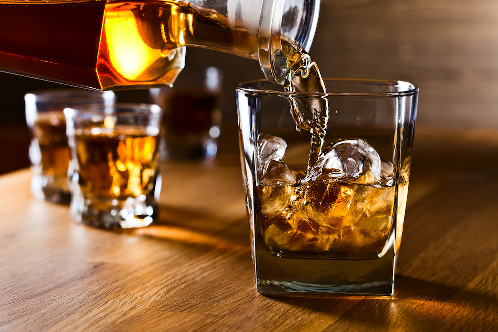 whiskey being poured into a glass